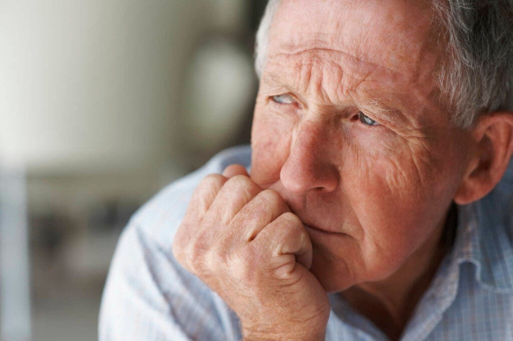 Elderly man in deep thought.